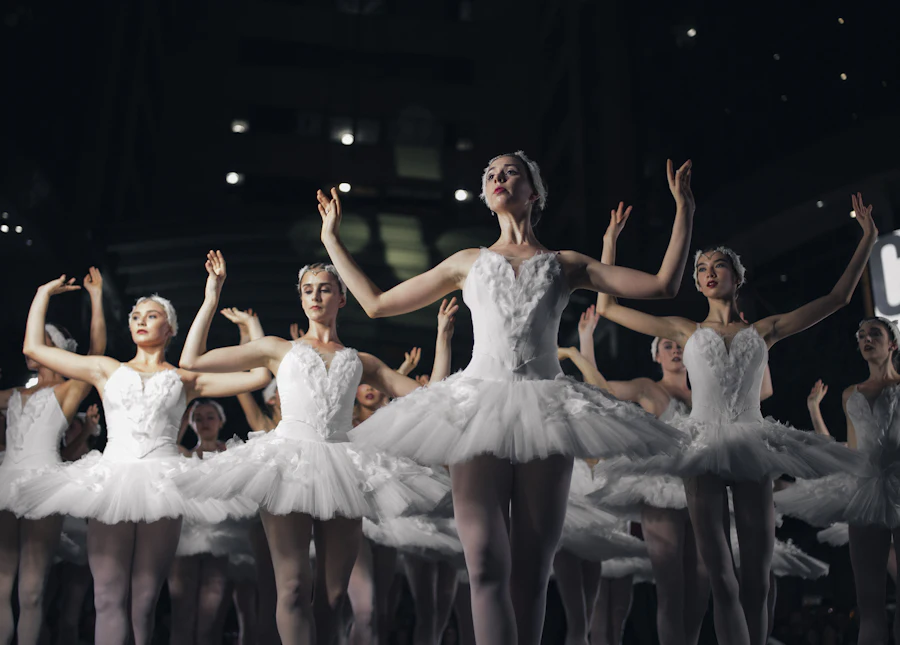 Ballet dancers in white tutus performing on stage